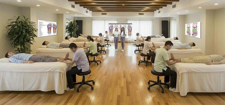 Group of people receiving reflexology treatments