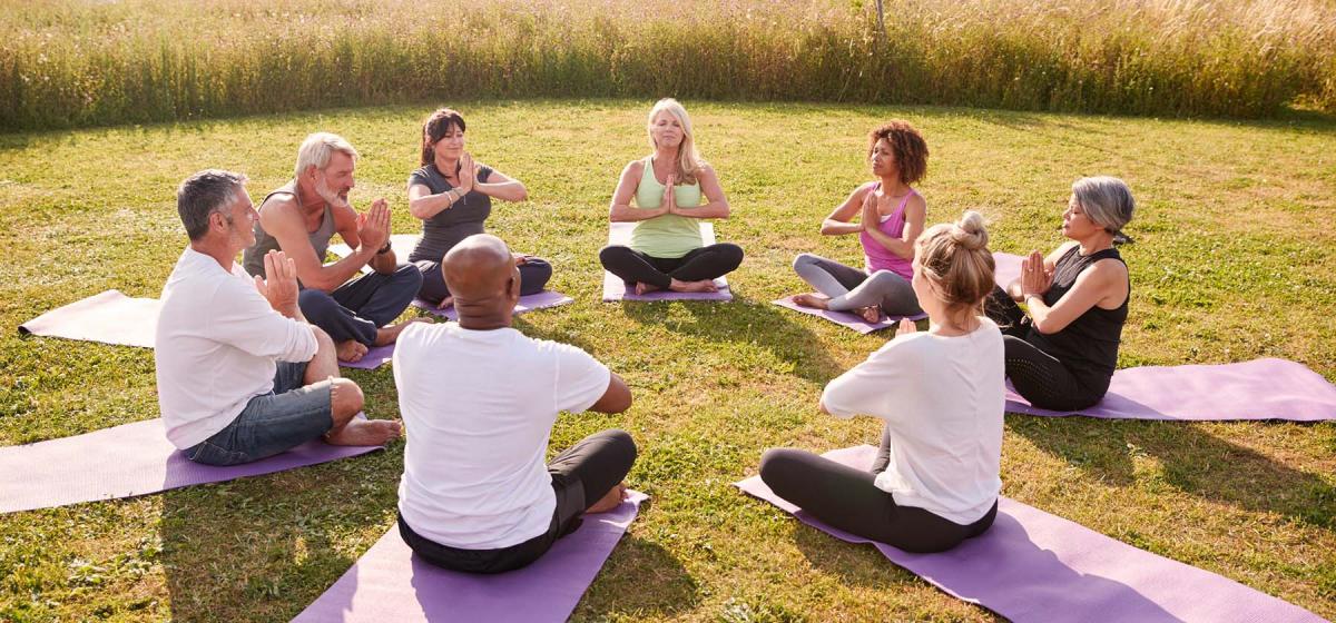 Group of people in yoga class outdoors