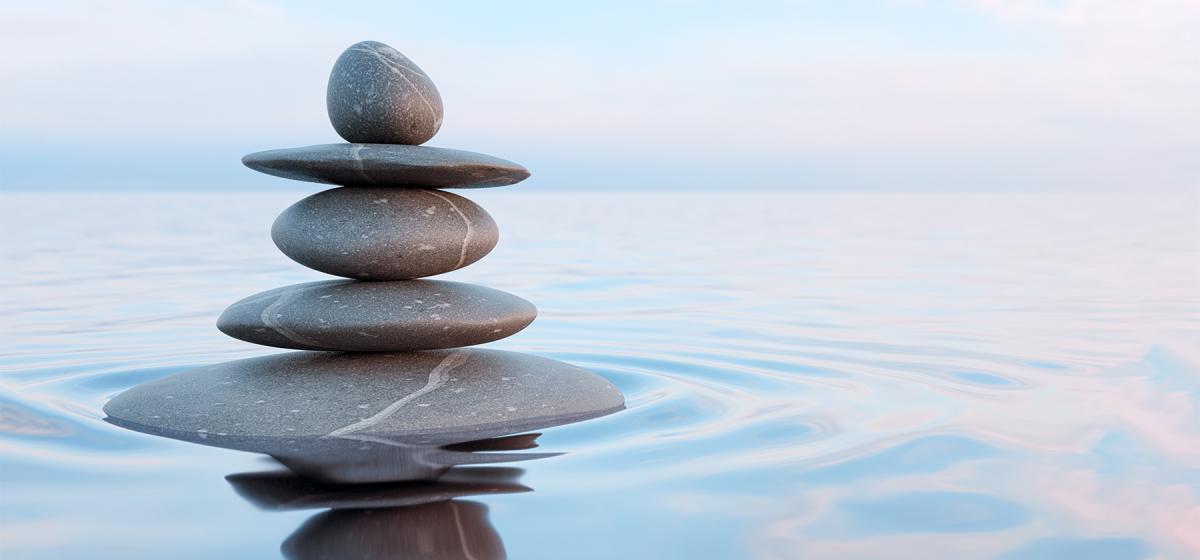 zen stack of stones in the water