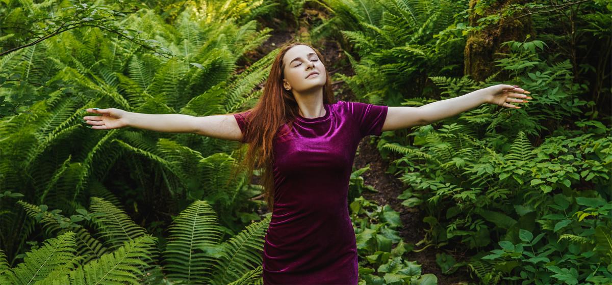 Person doing a breathwork practice in the woods