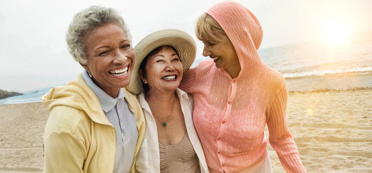 Group of happy middle-aged women on the beach