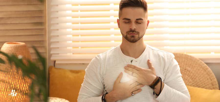 Man with hands near chest channeling energy