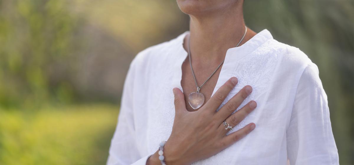 Person with hand over heart in serene self-compassion