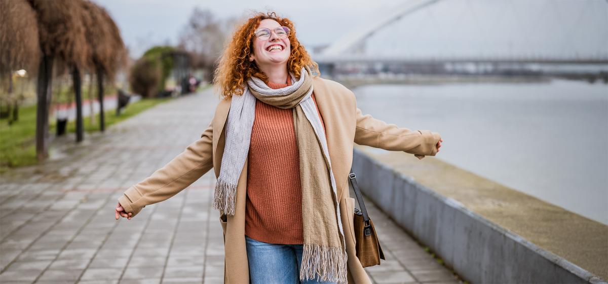 Woman walking alone on a path joyfully