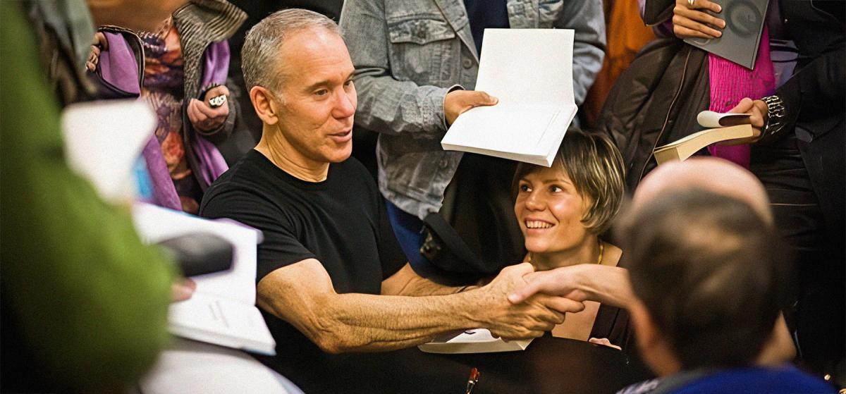Dan Millman shaking a participant's hand at a Peaceful Warrior event