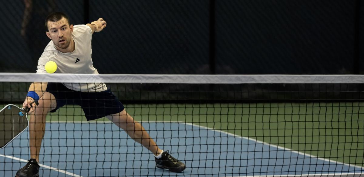 Francis Comesanas playing pickleball indoors.