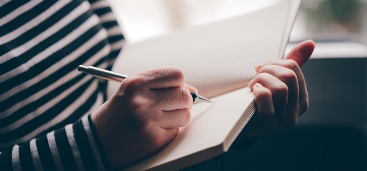 Person writing in a notebook