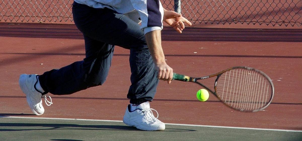 Person returning a tennis serve