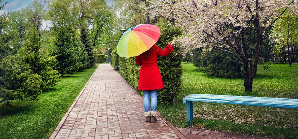 Woman with a bright umbrella in a park
