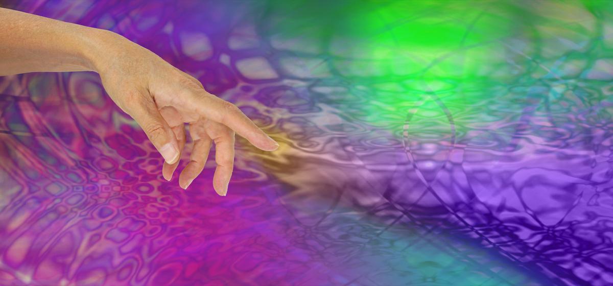 Hand in a rainbow colored pool