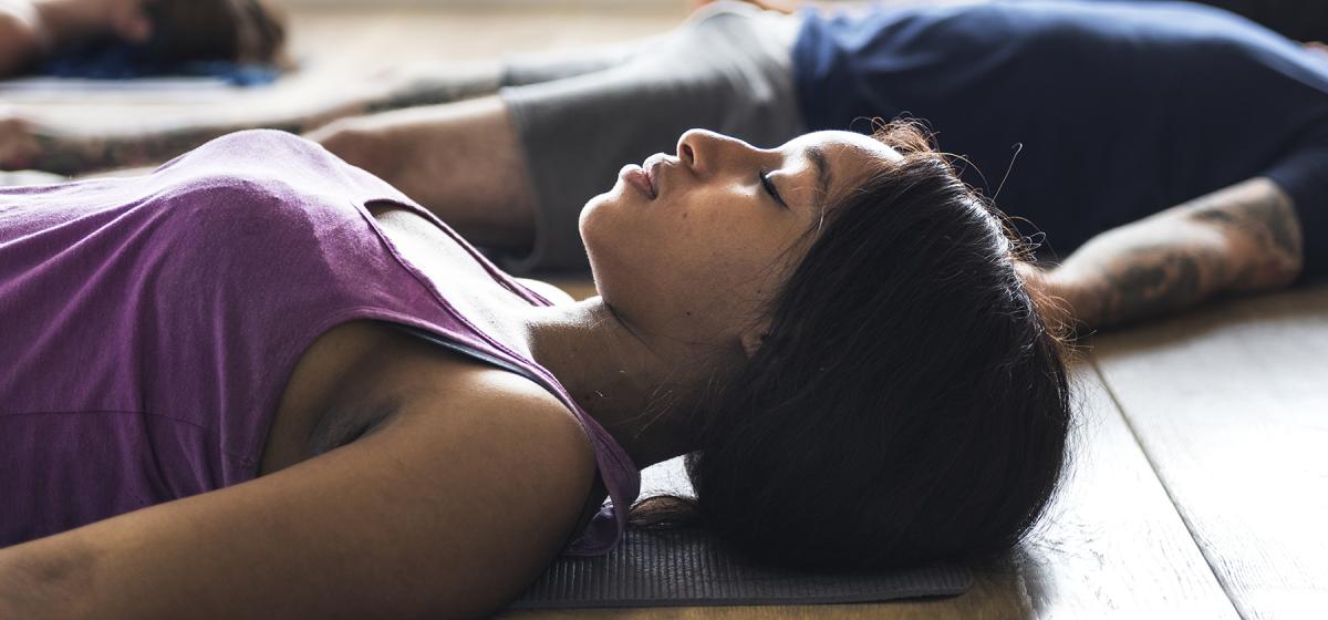 Group of people resting in a yoga studio