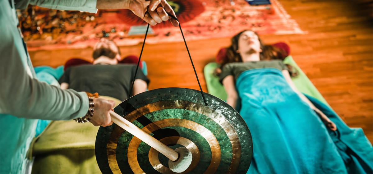 Group of people meditating with a gong