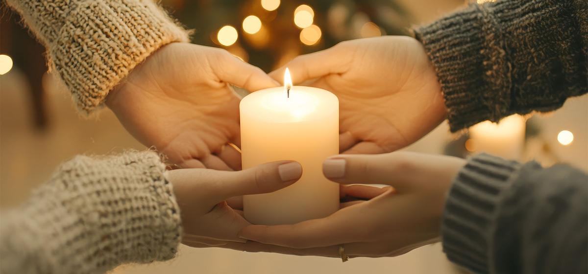 Hands holding a candle