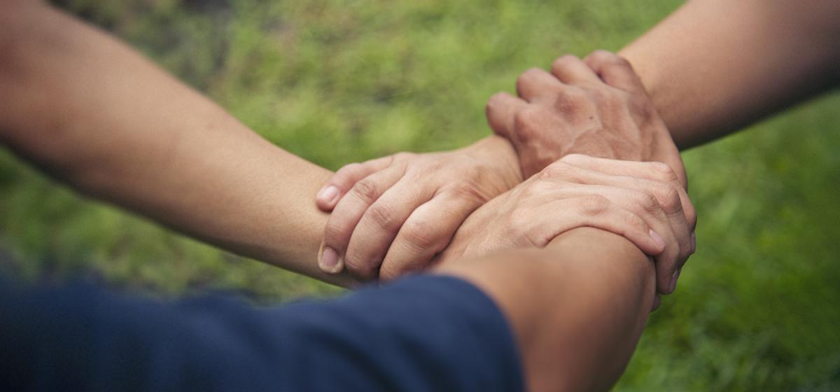 Group of people holding hands