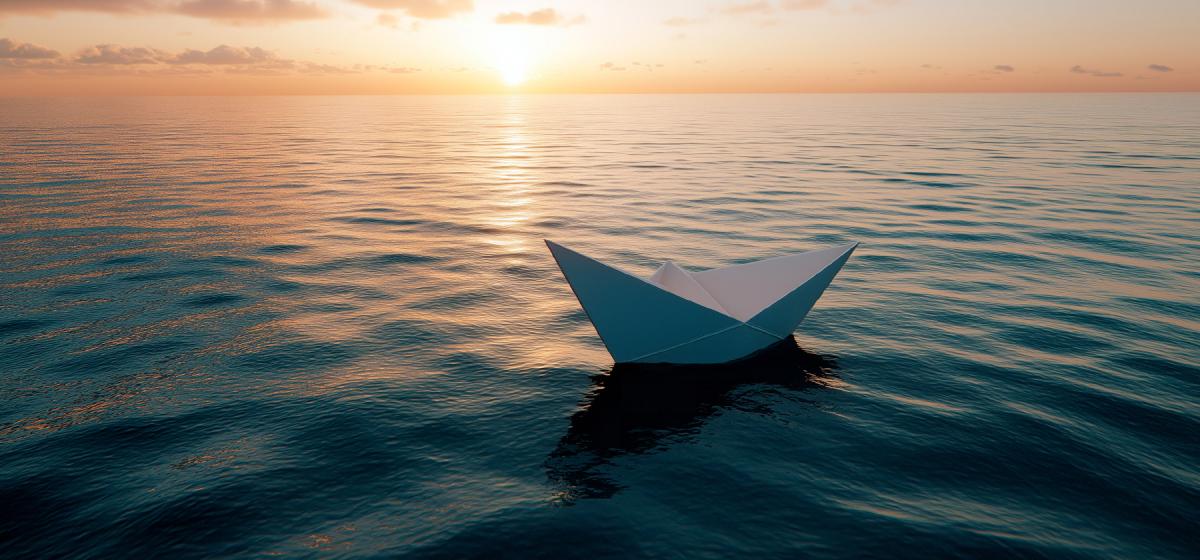 Paper boat floating peacefully in the ocean