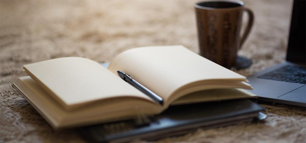 Open journal and cup of coffee