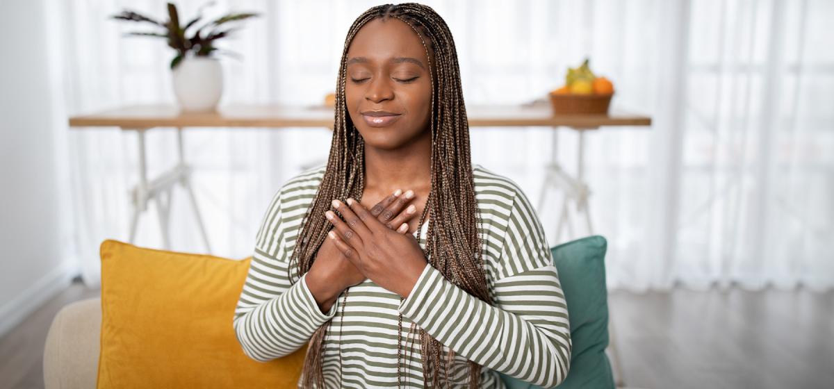 Woman with hands over heart