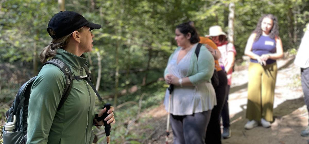 Sarah DeWitt leading a workshop in the forest