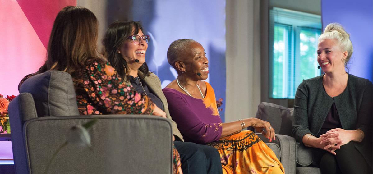 Group of Omega Womens Leadership faculty on stage at a conference