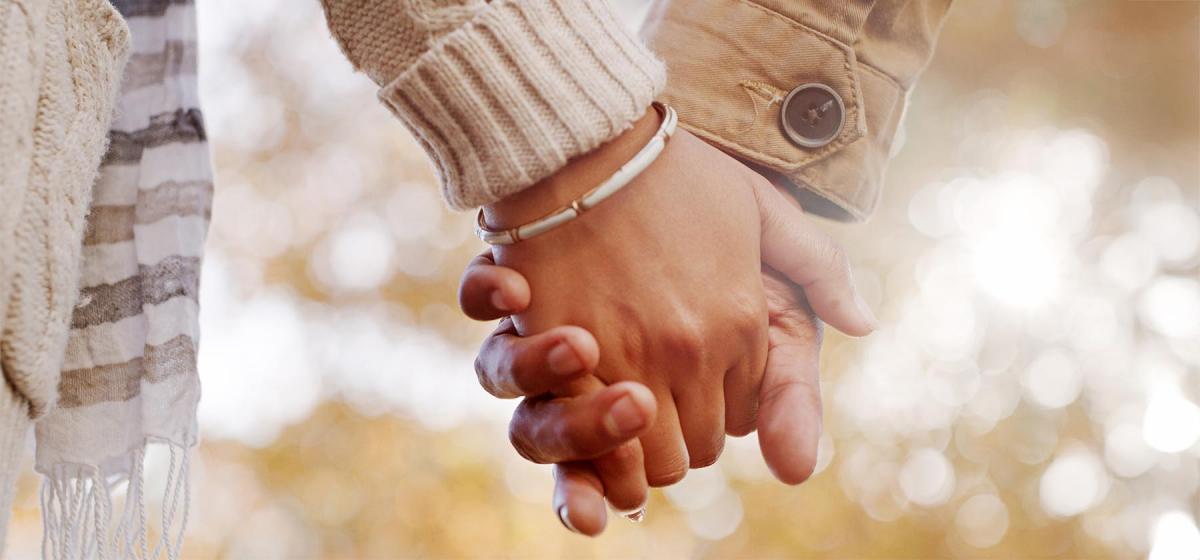 Closeup of couple holding hands