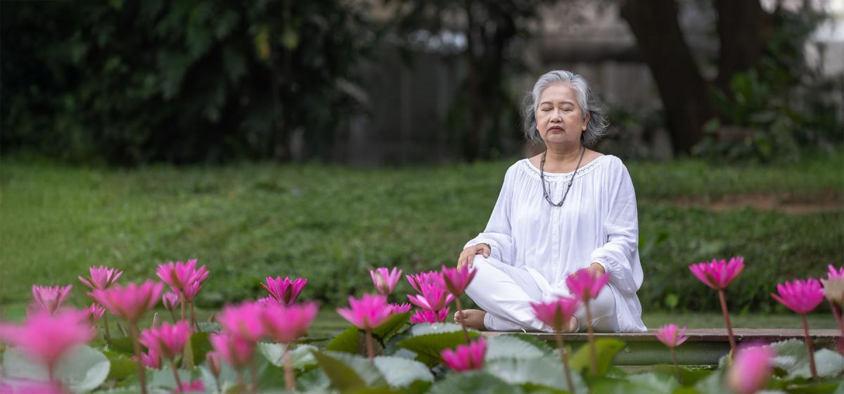 Elderly woman meditating