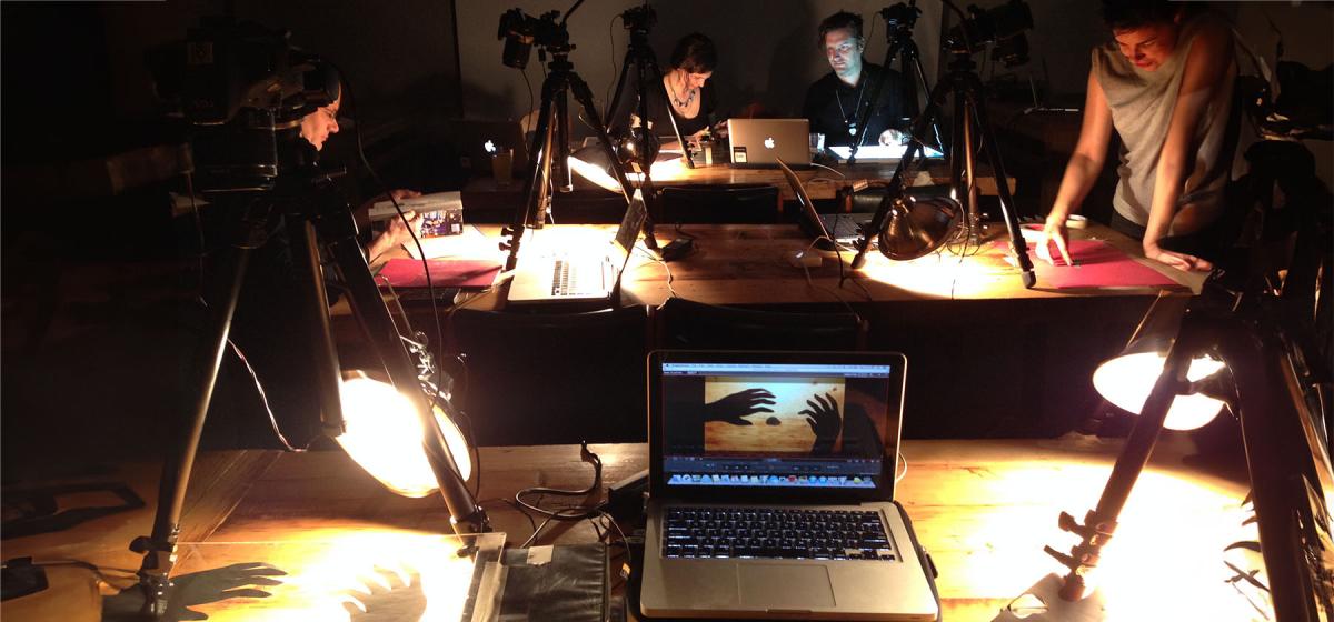 Group of students creating stop motion animations in a dimly lit studio