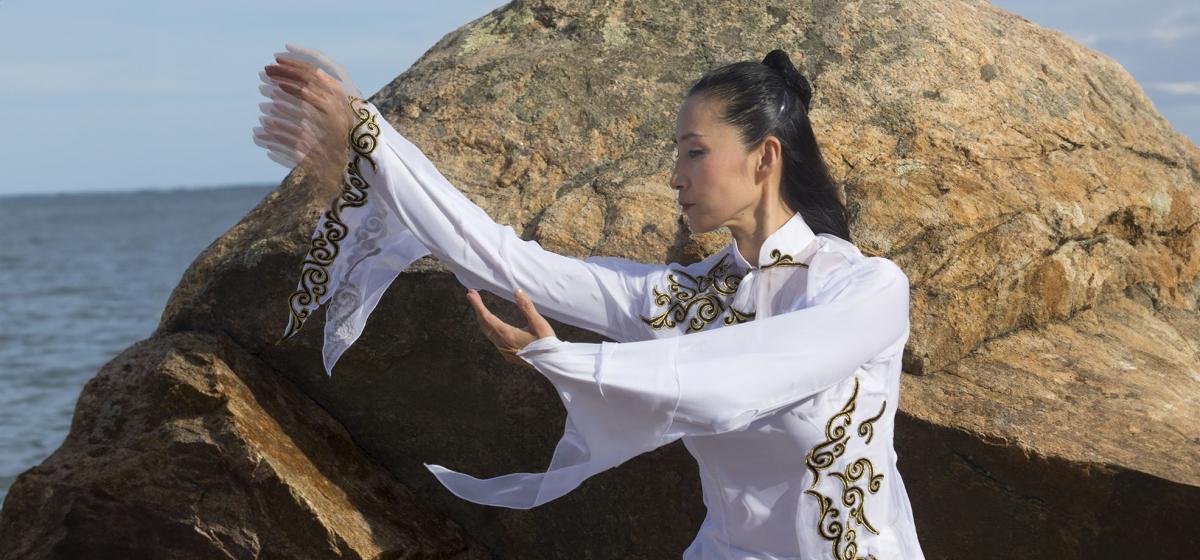 Lorelei Chang practicing qigong by the sea