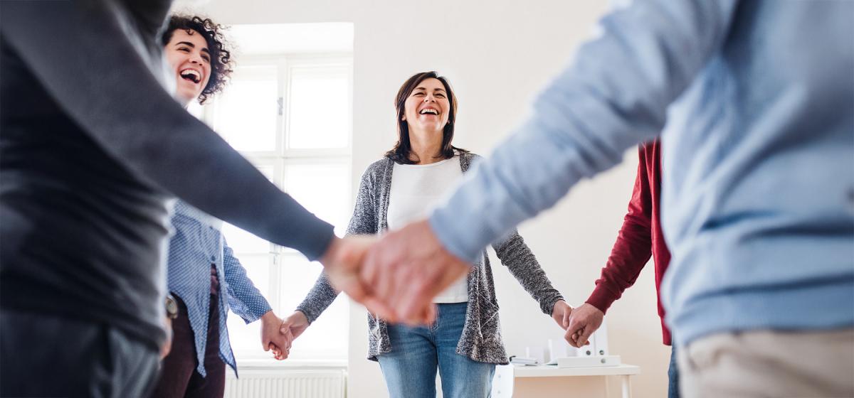 Group of people laughing in a workshop