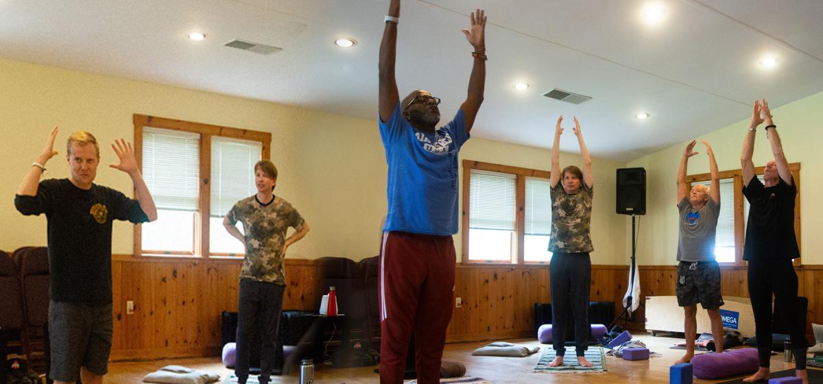 Group of male veterans in yoga practice at Omega