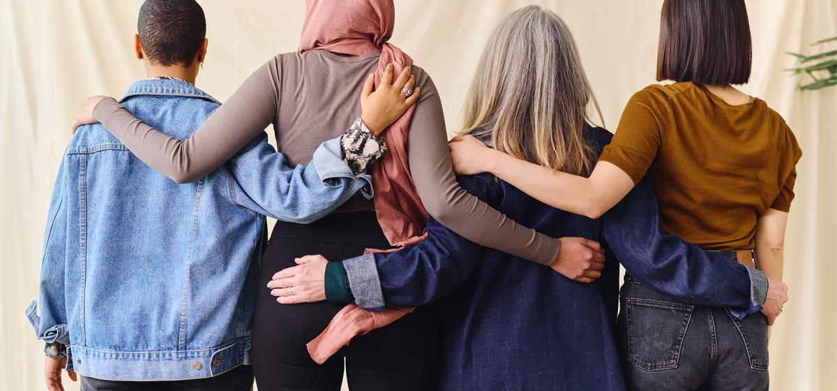 Group of women with arms around each other in support