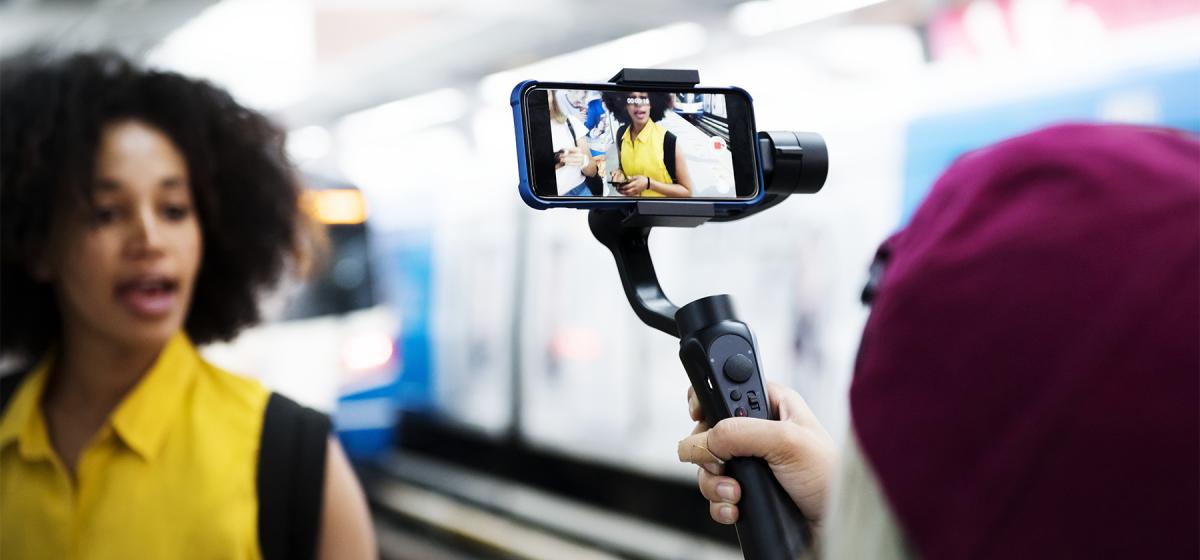 Person making a documentary film using a cell phone