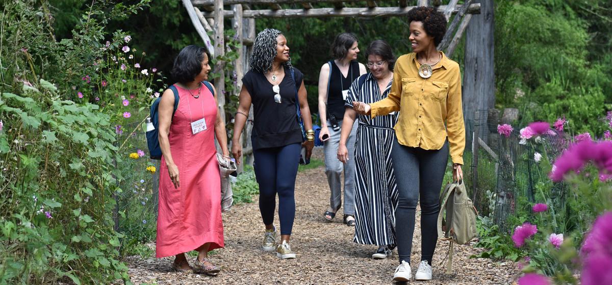 Women walking through Omega's garden