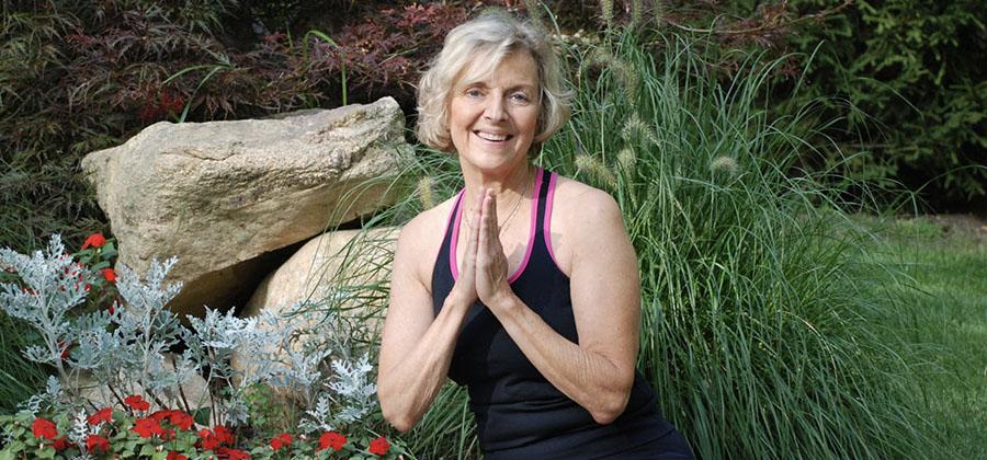 Beryl Bender Birch in yoga pose outside