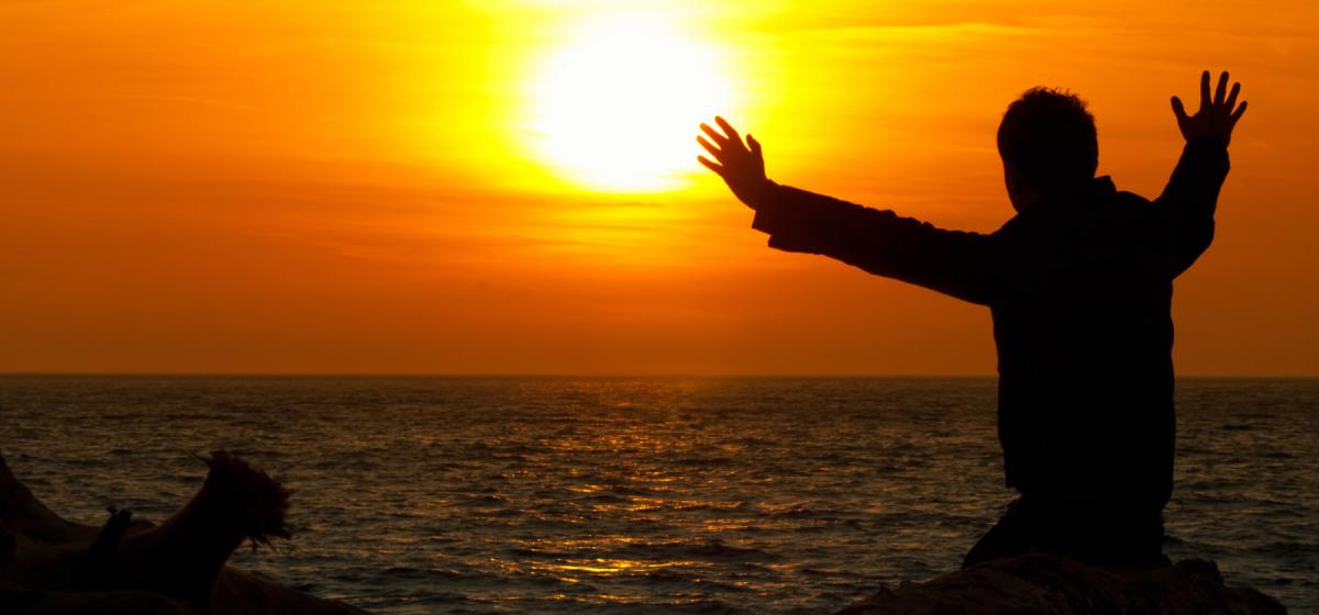 Person sitting and watching a beautiful sunset