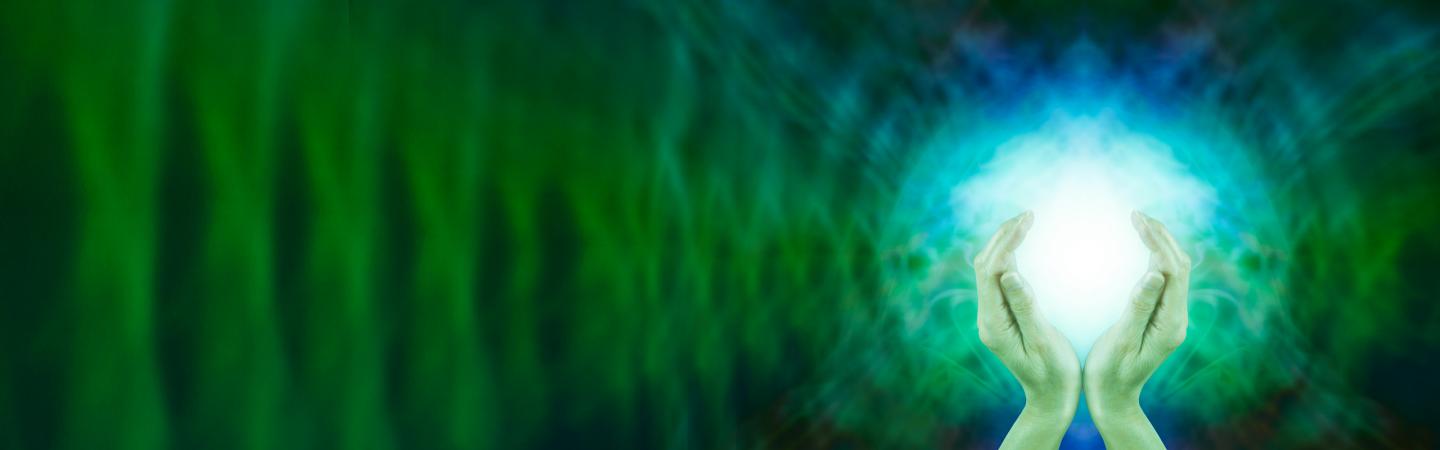 Hands holding glowing energy orb against a vibrant green background, symbolizing chi or life force energy.