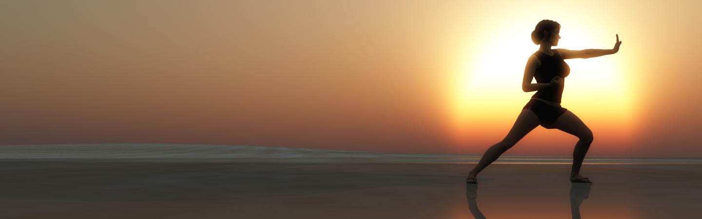 Woman practicing Tai Chi at sunrise on the beach, illustrating the flow of subtle energy like prana and qi for enhanced health and well-being.