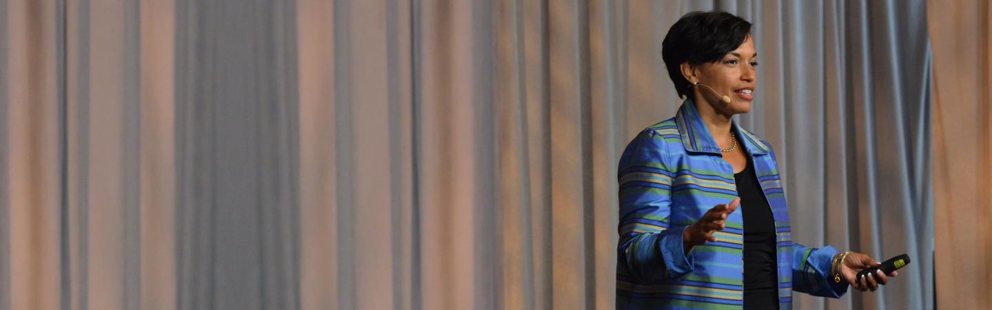 Bonnie St. John speaks on stage about leadership and resilience, inspiring audiences with her message of strength and recovery.