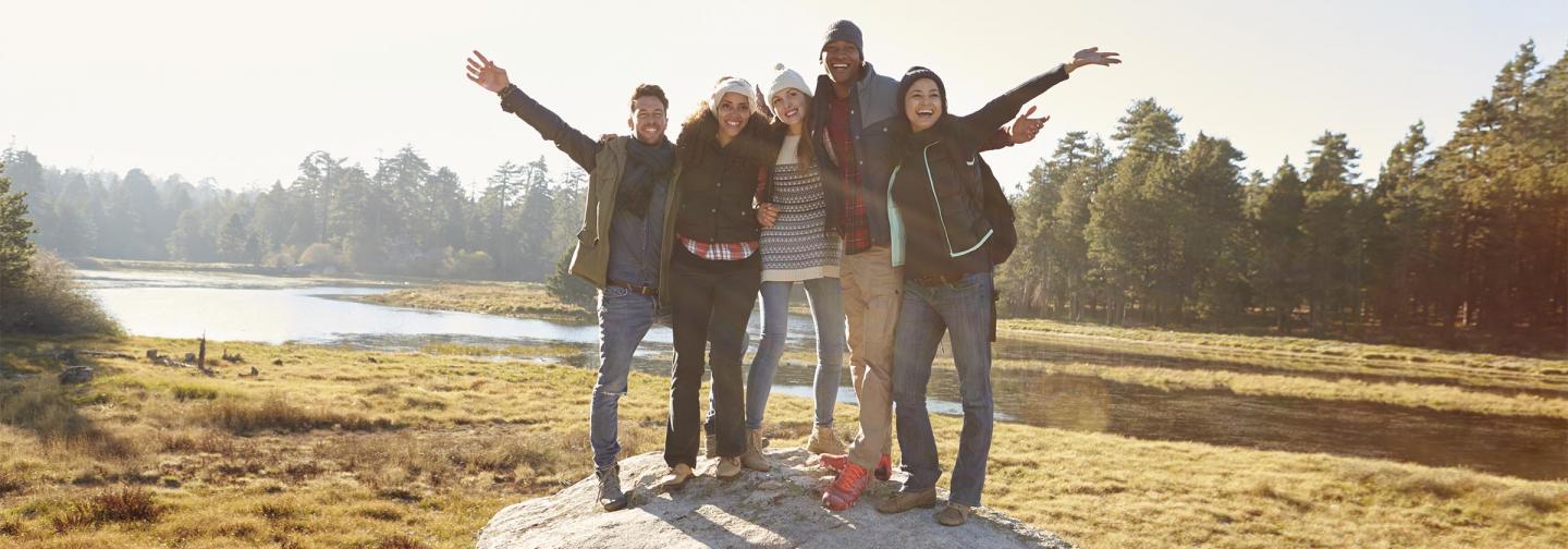 Group of friends standing on a rock