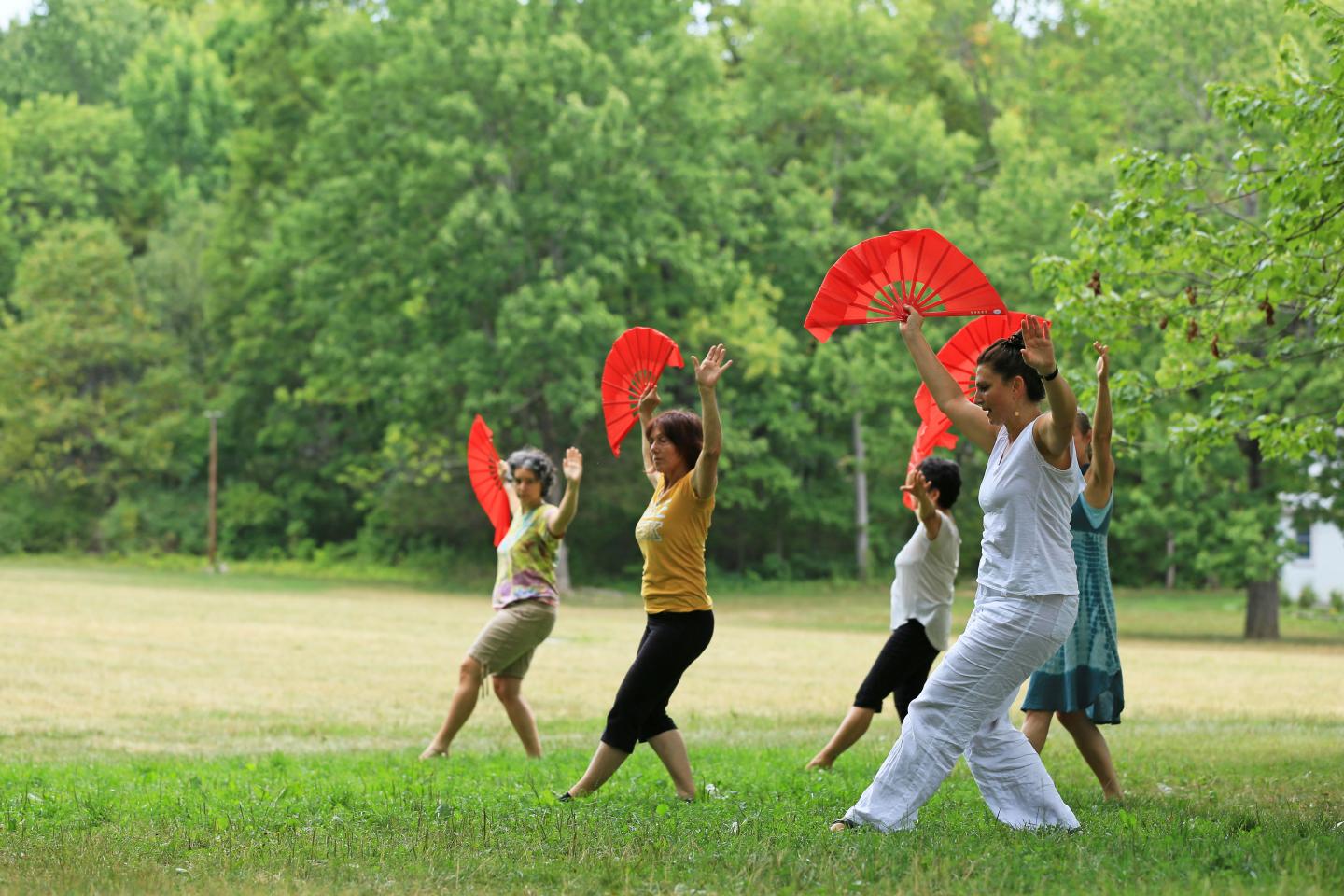 Women dancing with red scarves