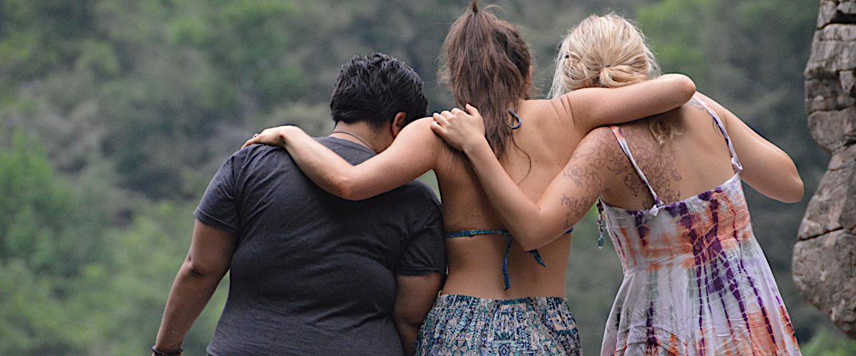 Women embracing in nature, representing emotional healing, human connection, and support for anxiety and grief.