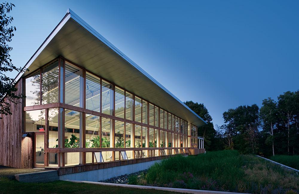 The Omega Center for Sustainable Living building at dusk