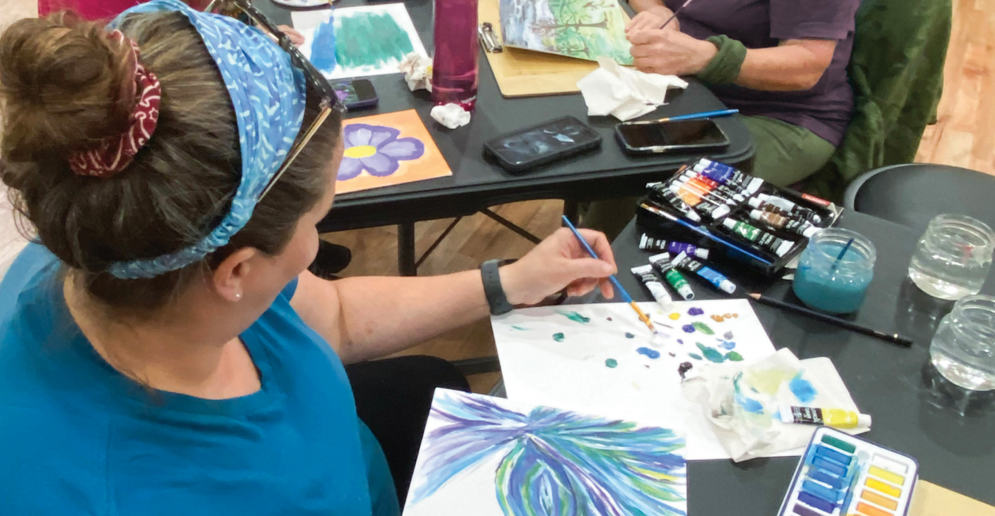 Woman paints in Art Class