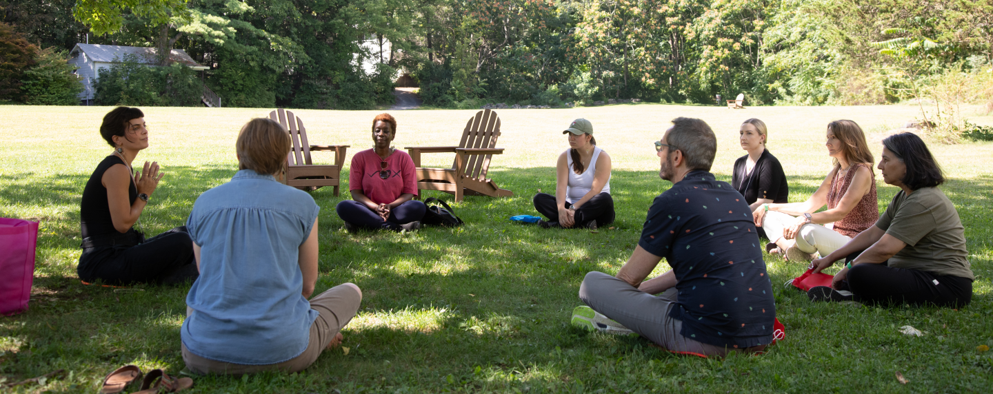 People sit in a circle outside