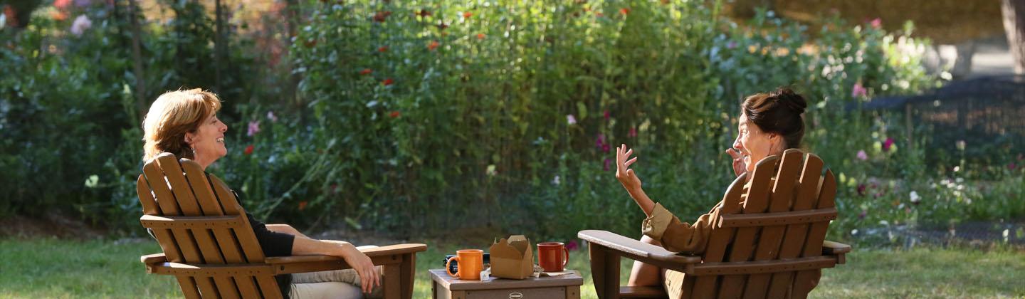 two women sipping tea in the garden