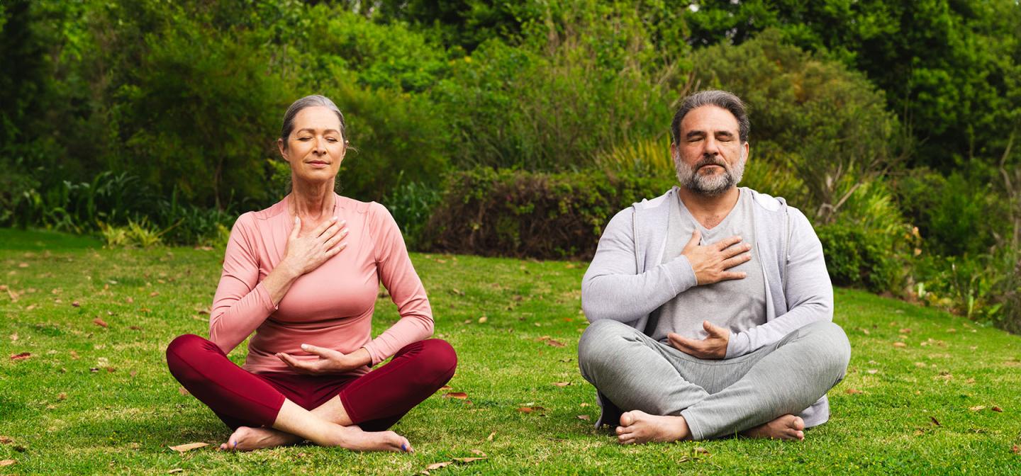 Participants practicing breathwork outdoors, focusing on conscious breathing and relaxation.