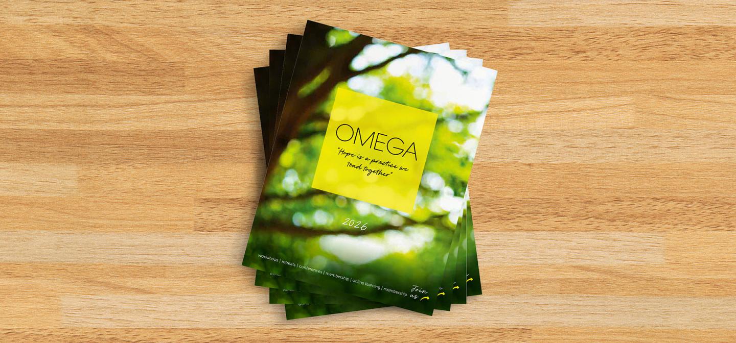 Omega 2026 catalogs on a wood table