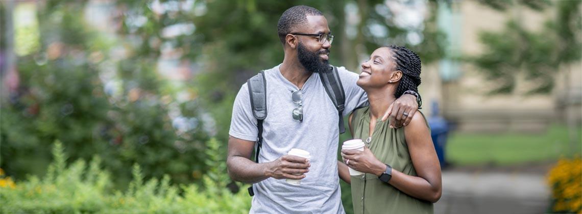 Man and woman smiling at each other because they have coffee