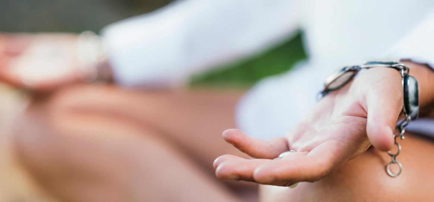 Person meditating at a mindfulness or meditation retreat.