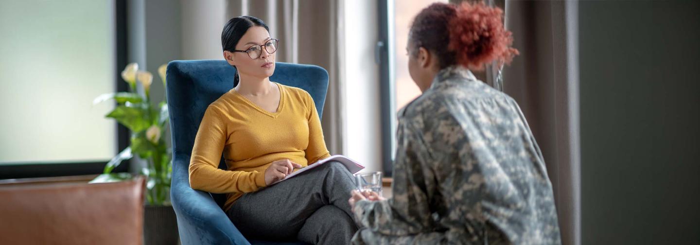 Therapist counseling a client, representing professional development and well-being resources for mental health practitioners