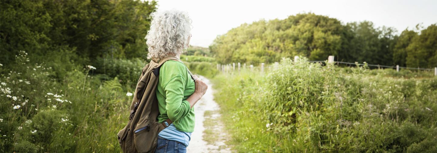 Woman walking along a pathway in nature, creating her future.